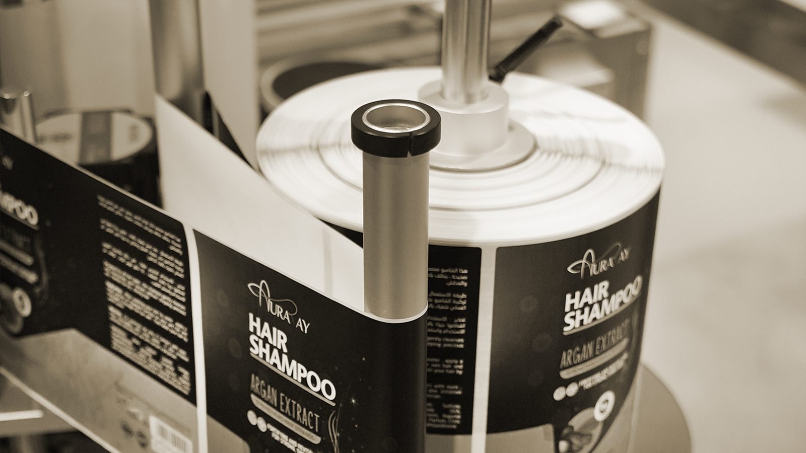 Auraray shampoo label reels running through the labelling machine